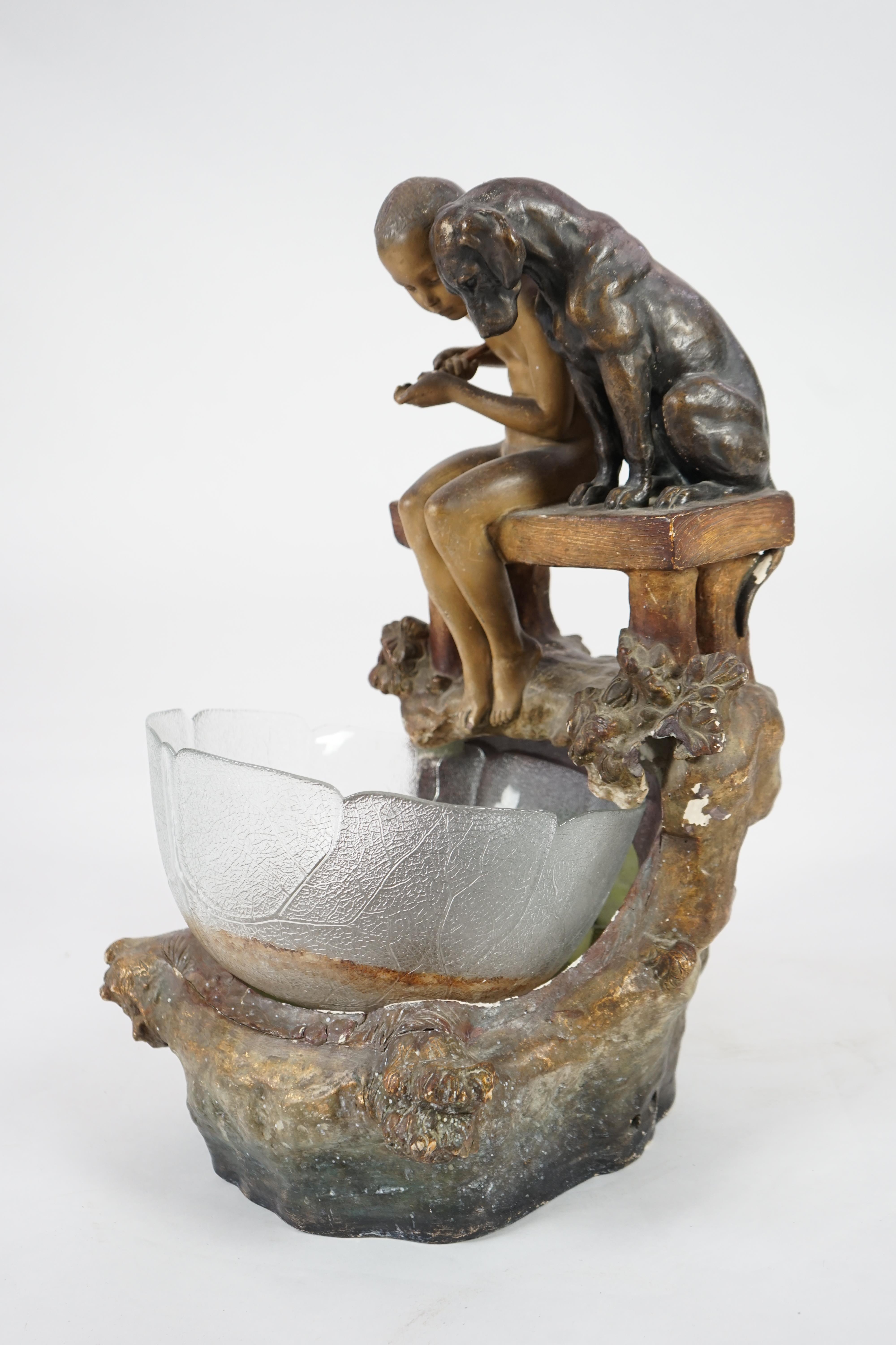 A Goldscheider group of a boy and a dog looking into a pool. Condition - fair, glass bowl not original